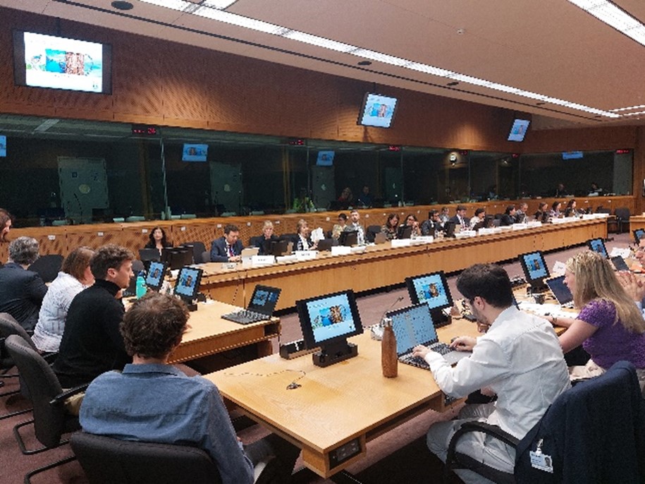 People are seated in a meeting room