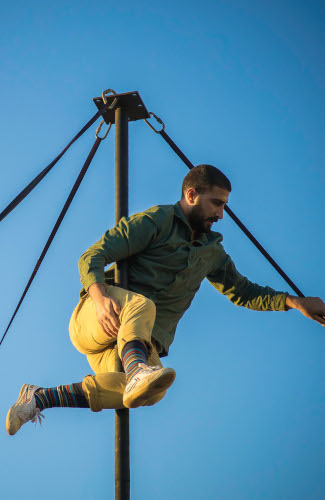 A young Palestinian is suspended in mid-air