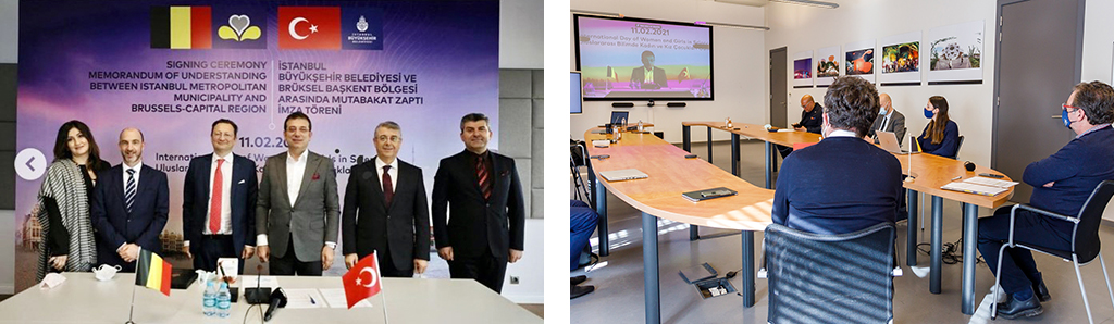 The signatories, standing in front of a commemorative poster of the signing of the MoU.