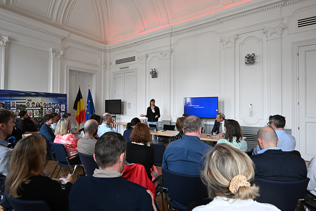Participants listen to a speaker's presentation 