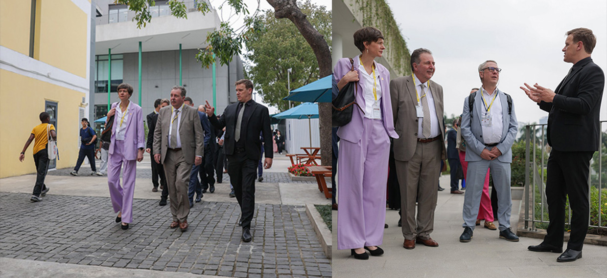 A guide gives an explanation to delegation members during their visit to the school.
